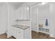 Mudroom with granite countertop, white cabinets, and built-in bench with hooks at 2461 Palmdale Walk Dr, Fort Mill, SC 29708