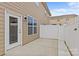 Back patio with white fence, tan siding, and glass patio door at 2461 Palmdale Walk Dr, Fort Mill, SC 29708