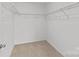 Walk-in closet with white wire shelving and beige carpeting at 2461 Palmdale Walk Dr, Fort Mill, SC 29708
