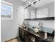 This bathroom features double sinks with glass countertops and modern fixtures and neutral walls at 250 W Bland St, Charlotte, NC 28203