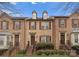 Charming brick townhome showcasing symmetrical design, dormer windows, and well-maintained landscaping at 250 W Bland St, Charlotte, NC 28203