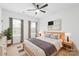 Modern bedroom featuring neutral decor, a ceiling fan, and a sun-filled window at 2809 New Pineola Rd, Charlotte, NC 28208