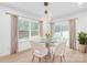 Bright dining room with round glass table and backyard view through large windows at 2809 New Pineola Rd, Charlotte, NC 28208