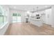 Well-lit open kitchen with stainless steel appliances and large windows at 2809 New Pineola Rd, Charlotte, NC 28208