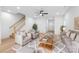 Bright living room with modern furnishings, open staircase, and light hardwood floors at 2809 New Pineola Rd, Charlotte, NC 28208