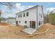 Exterior view of a home with a white siding and a backyard patio at 2811 New Pineola Rd, Charlotte, NC 28208
