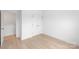 A bedroom showcasing the closet and door to another room, with light wood floors at 2811 New Pineola Rd, Charlotte, NC 28208