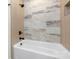 The stunning tub and tiled shower are a highlight of this home at 3907 Plainview Rd, Charlotte, NC 28208