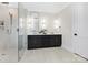 Elegant bathroom with a walk-in shower and stylish vanity featuring double sinks and modern lighting at 3907 Plainview Rd, Charlotte, NC 28208