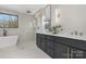 Luxurious bathroom featuring a soaking tub, a frameless glass shower, and a double vanity with modern fixtures at 3907 Plainview Rd, Charlotte, NC 28208