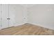 This bedroom offers ample space, recessed lighting, and is adjacent to a large closet at 3907 Plainview Rd, Charlotte, NC 28208