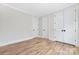 Bright bedroom featuring wood floors, neutral walls, and ample closet space at 3907 Plainview Rd, Charlotte, NC 28208