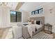 Serene bedroom with a luxurious upholstered bed, wood beams and plenty of natural light from the window at 3907 Plainview Rd, Charlotte, NC 28208