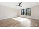 Inviting bedroom with wood flooring, modern ceiling fan, and large window offering ample natural light at 3907 Plainview Rd, Charlotte, NC 28208