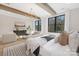 Spacious bedroom offers wood beam ceilings, hardwood floors, a sitting area and large windows with natural light at 3907 Plainview Rd, Charlotte, NC 28208