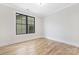 Cozy bedroom featuring wood floors, neutral walls, and a window providing natural light at 3907 Plainview Rd, Charlotte, NC 28208