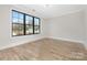 Bright bedroom with large window, wood flooring, and neutral walls creating a serene atmosphere at 3907 Plainview Rd, Charlotte, NC 28208