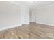 Spacious bedroom with neutral walls, wood flooring, and ample space for comfortable living at 3907 Plainview Rd, Charlotte, NC 28208