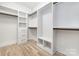 Walk-in closet features built-in shelving, drawers, and hanging rods for optimal storage and organization at 3907 Plainview Rd, Charlotte, NC 28208