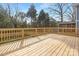 Spacious wooden deck with railing and access to screened-in porch, perfect for outdoor entertaining at 3907 Plainview Rd, Charlotte, NC 28208