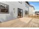 The back deck of the home features wood flooring and stylish lighting at 3907 Plainview Rd, Charlotte, NC 28208