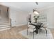 Bright dining space features modern lighting, a stylish table set, and easy access to the staircase at 3907 Plainview Rd, Charlotte, NC 28208