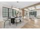 Bright dining room features modern chandelier, hardwood floors, and open floor plan to the inviting living room space at 3907 Plainview Rd, Charlotte, NC 28208