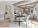 Dining room boasts wood beams, a modern fireplace, and a light-filled open floor plan to the living room at 3907 Plainview Rd, Charlotte, NC 28208
