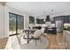 Eat-in kitchen featuring an island with seating and stainless steel appliances, open to a dining area at 3907 Plainview Rd, Charlotte, NC 28208