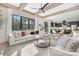 Bright, open-concept living room with exposed wood beams, a ceiling fan, and views into the modern kitchen at 3907 Plainview Rd, Charlotte, NC 28208