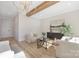 Bright living room featuring hardwood floors and a cozy sitting area with a decorative cabinet at 3907 Plainview Rd, Charlotte, NC 28208