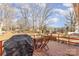Back deck overlooking the yard with a grill, chairs, and seasonal views of the outdoors at 4000 Elizabeth St, Hickory, NC 28601