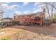 Exterior view of a brick house with a back deck, patio, and spacious backyard at 4000 Elizabeth St, Hickory, NC 28601