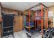 Wood-paneled basement transformed into a home gym, complete with a treadmill and weight rack at 4000 Elizabeth St, Hickory, NC 28601