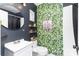 Stylish bathroom featuring tropical wallpaper, a round mirror, and decorative shelving at 4000 Elizabeth St, Hickory, NC 28601
