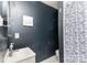 Cozy bathroom featuring dark blue walls and a charming, patterned shower curtain at 4000 Elizabeth St, Hickory, NC 28601