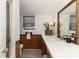 This bathroom features wood paneling, a window with sheer curtains, and an elongated vanity at 4000 Elizabeth St, Hickory, NC 28601