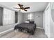 Cozy bedroom with gray walls, a ceiling fan, a window with curtains, and new wood flooring at 4000 Elizabeth St, Hickory, NC 28601