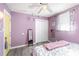 Bedroom with light lavender-colored walls, laminate floors, and a closet with white doors at 4000 Elizabeth St, Hickory, NC 28601