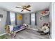 Cozy, light gray bedroom features laminate floors, large windows, and stylish decor at 4000 Elizabeth St, Hickory, NC 28601