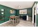 Inviting dining space with green walls, light wood floors, and modern furnishings at 4000 Elizabeth St, Hickory, NC 28601
