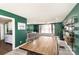 Open-concept dining area featuring green walls and views into the living room at 4000 Elizabeth St, Hickory, NC 28601