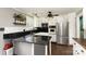 Well-lit kitchen with black countertops, white cabinets, and stainless steel appliances at 4000 Elizabeth St, Hickory, NC 28601