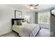 Cozy bedroom with plush bedding, neutral tones, and a large window for natural light at 4230 Black Ct # 235, Harrisburg, NC 28075