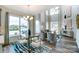Bright dining area with large windows, a stylish table, and a view into the living area at 4230 Black Ct # 235, Harrisburg, NC 28075