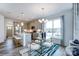 Stylish dining area adjacent to the kitchen with a modern table and seating, with an abundance of natural light at 4230 Black Ct # 235, Harrisburg, NC 28075