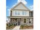 Charming two-story home with stone accents, covered porch, and manicured landscaping creates curb appeal at 4230 Black Ct # 235, Harrisburg, NC 28075