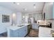 Well-designed kitchen with a central island, stainless steel appliances, and gray cabinets at 4230 Black Ct # 235, Harrisburg, NC 28075