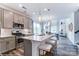 Modern kitchen featuring a large island with seating, stainless steel appliances, and an open concept design at 4230 Black Ct # 235, Harrisburg, NC 28075
