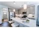 Modern kitchen featuring a large island with seating, stainless steel appliances, and ample cabinet space at 4230 Black Ct # 235, Harrisburg, NC 28075